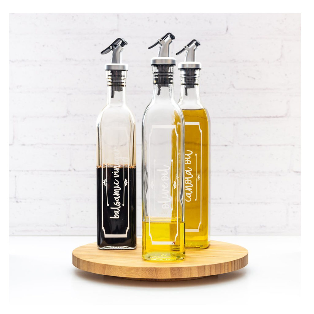 3 olive oil bottles with olive oil and one with balsamic vinegar.